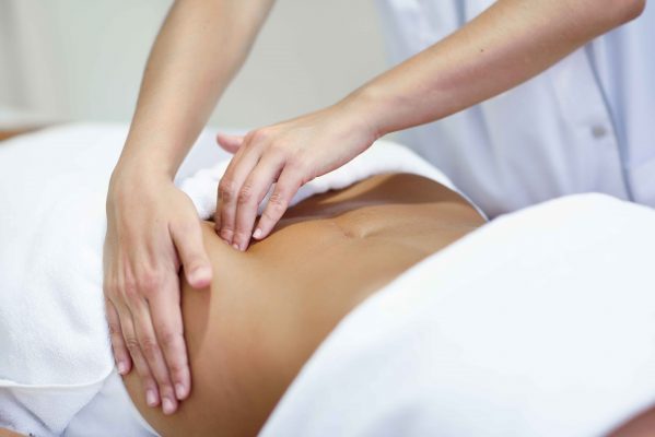 Woman receiving fertility massage treatment