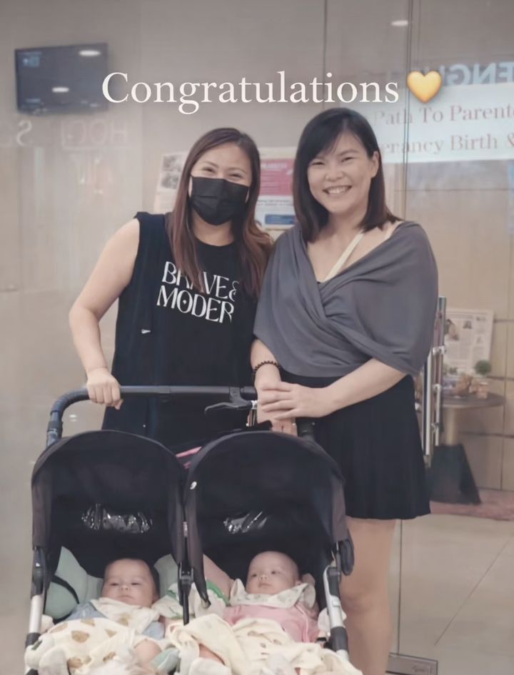 Twins in a stroller with their mummy